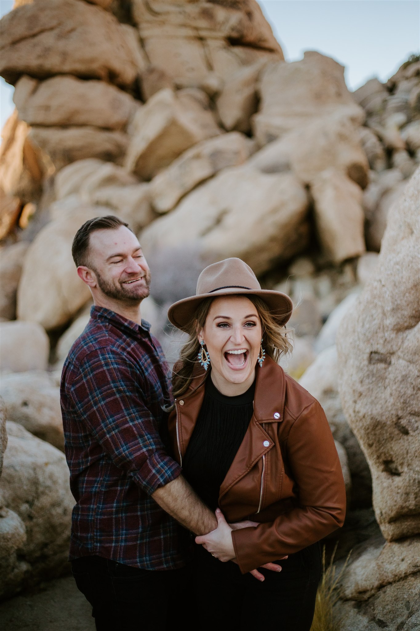 A couple laughing among the rocks in Joshua Tree