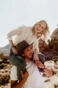 couple in engagement session doing piggyback